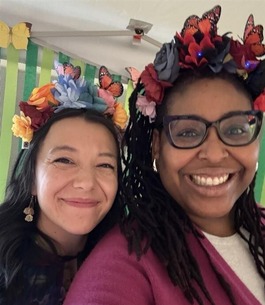 OPA Staff taking a selfie. They are smiling and wearing butterfly flower crowns. 