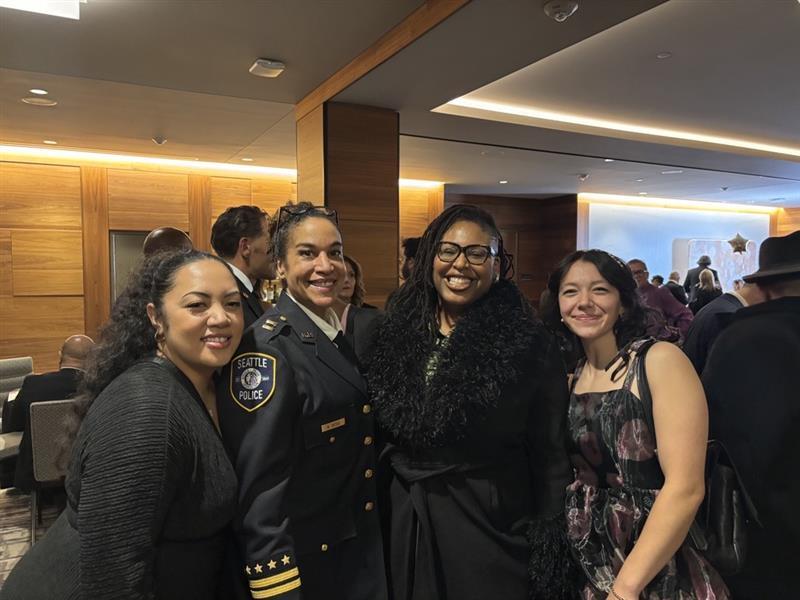 OPA staff posing with SPD Captain Heidi Tuttle, who is dressed in uniform.