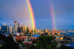 two rainbows over a city landscape
