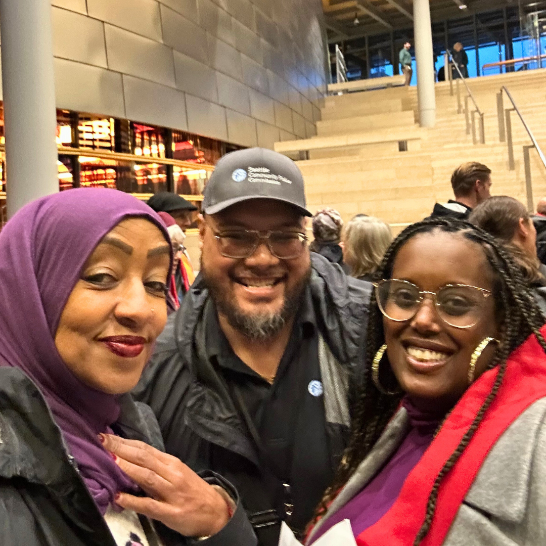 Mario & Mergitu with a community advocate at Public Hearing on the City Budget