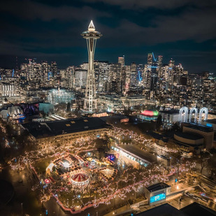 An aerial view of the Seattle Christmas Market at night with twinkly lights