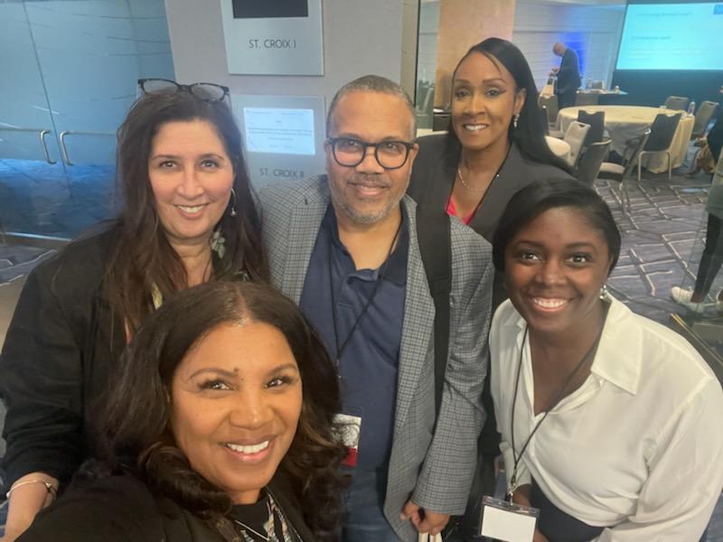 OPA Director Bonnie Glenn with four members of NACOLE taking a selfie in a convention center space.