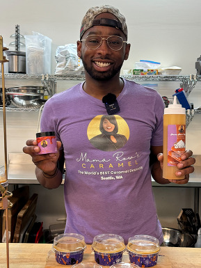 Jonathan Hudson holding up some of his caramel products