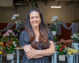 seattle restored participant standing in front of her store