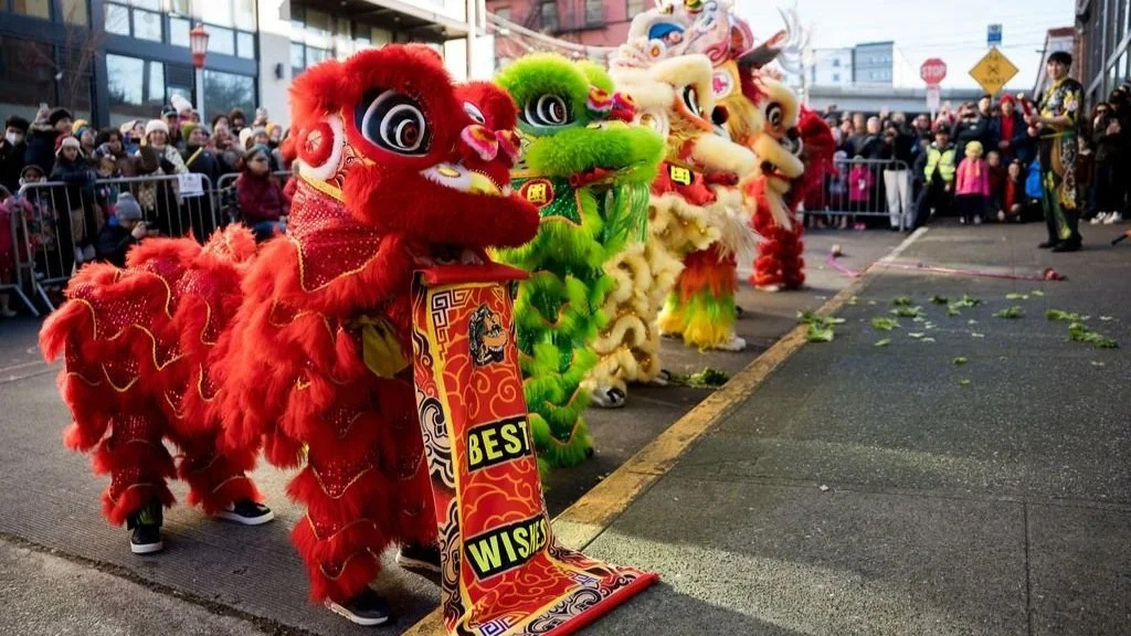 a group of dancers in lion costumes during a lunar new year lion dance blessing