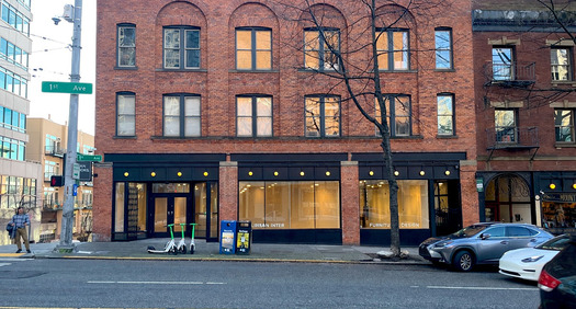 A brick building featuring the Pioneer Collective working space