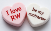 Photo of two candy conversation hearts, one reads "I love RW" and the other "be my contractor" 