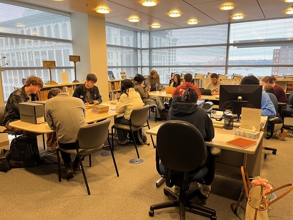 Color image of students sitting at tables and studying in the SMA archives research room