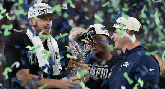 Seahawks QB Sam Darnold and head coach Mike Macdonald lift the Lombardi Trophy in a flurry of blue and green confetti