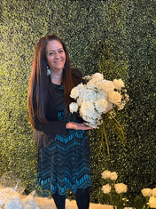 RMC Flora Designs owner holding flower bouquet