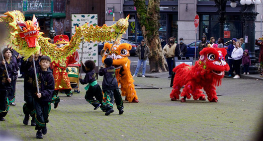 Small children participating in a lion dance during a Lunar New Year celebration