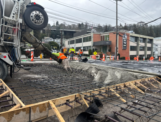 Crews pour new concrete near KIRO Newsradio. 