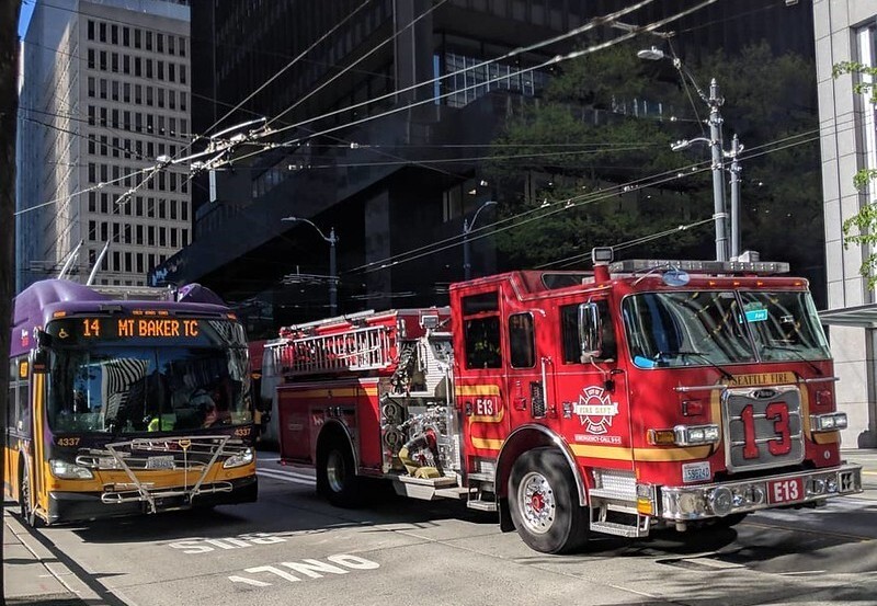 First responders pass a King County Metro bus. 