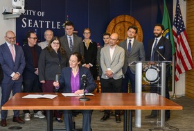 Mayor Wilson signing CM Lin's bill to speed the development of housing and shelter