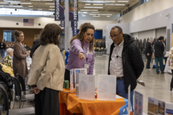 People talking over a table at a resource event.