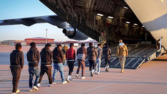 A photo of immigrants boarding a plane.
