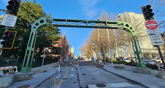 A green restored bridge sign from the Alaskan Way Viaduct on Bell Street
