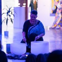 A woman plays soundbowls