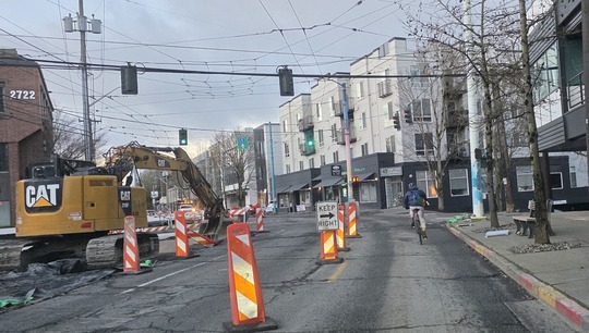 Bicyclist traveling beside the construction areas at Eastlake Ave E and E Hamlin St. 