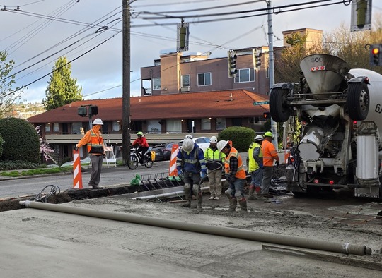 Crews pour new concrete on Eastlake Ave E near E Roanoke St 