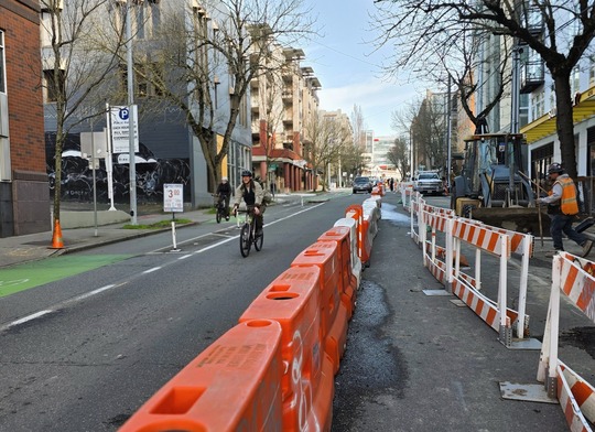 A path is provided for pedestrians around the sidewalk construction on Roosevelt Way NE. 