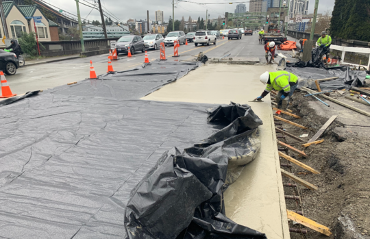 Crews smooth out new concrete at the intersection of Fuhrman Ave E and Eastlake Ave E. 