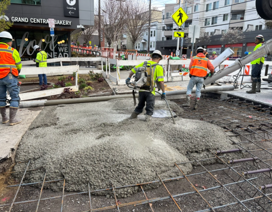 New concrete is poured at the intersection of Eastlake Ave E and E Blaine St. 