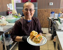 Tanya Nguyễn, owner of Chu Minh Tofu, holding a sandwich