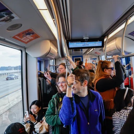 People taking the light rail across lake