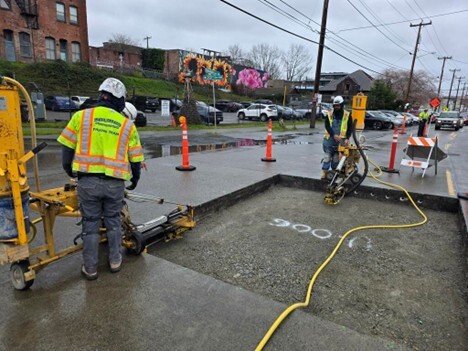 Workers prepare to repave a section of Shilshole Ave NW.