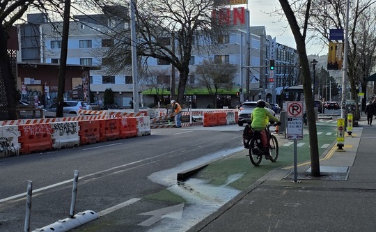 Crews install new sidewalks on the east side of Roosevelt Way NE. Traffic is shifted to the west side. 