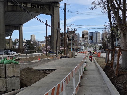 Barriers create temporary pathways for people walking or riding bikes near the construction areas on Eastlake Ave E. 