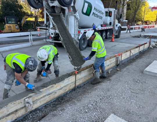 Crews pour new concrete curbs near the intersection of Eastlake Ave E and Harvard Ave E. 