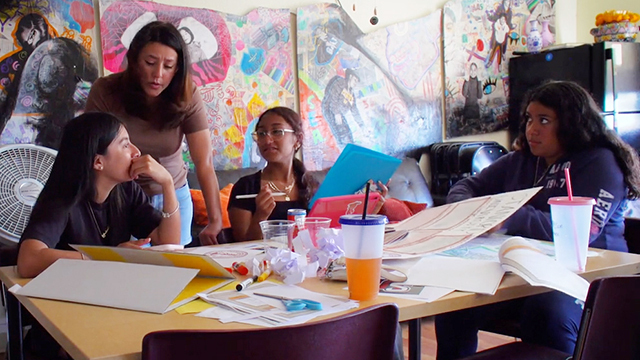 El Centro de la Raza staff work with teenagers on job resumes.