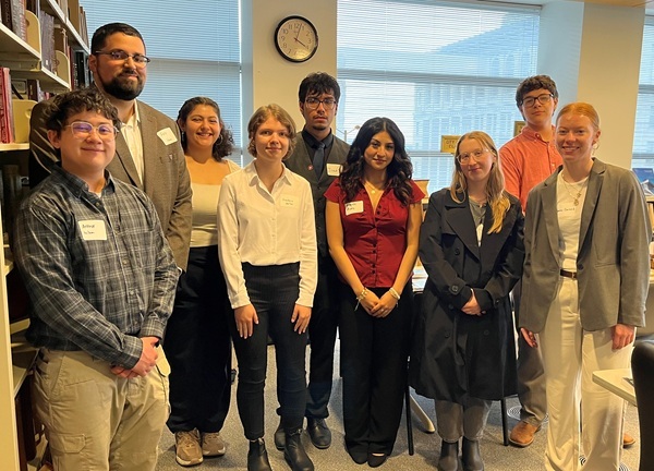 Color photo of a group of WSU college students standing in SMA's research room