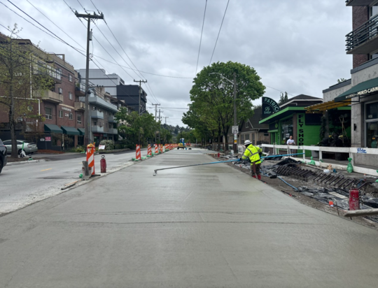 Crews smooth out new concrete near Patrick’s Fly Shop.