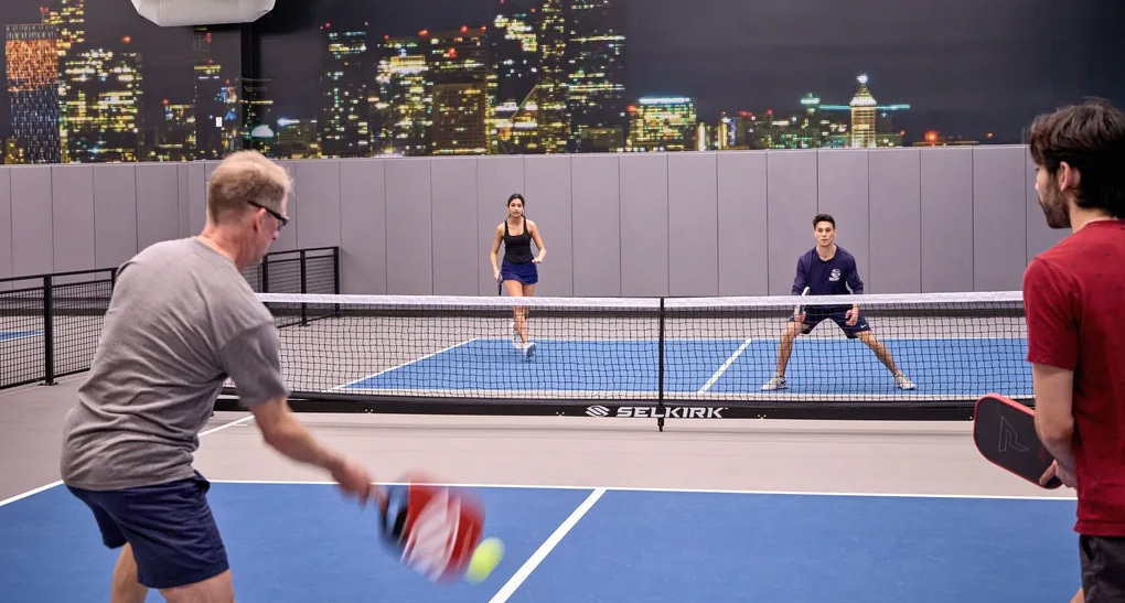 People playing pickleball on a court inside Rainier Square tower