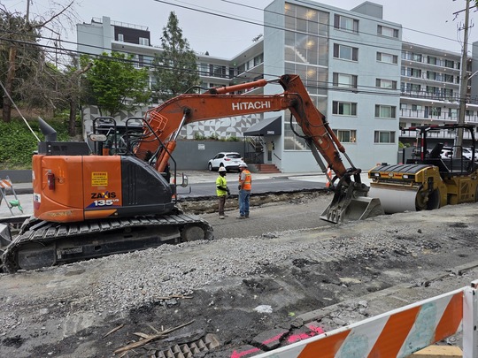 Crews smooth out the ground before pouring new concrete on top.