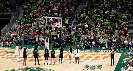 A Seattle Storm game with the crowd making noise and waving towels