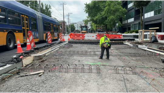 Crews install metal supports before pouring new concrete.
