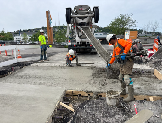 Crews pour new concrete on one half of the Fairview Ave N and Aloha St intersection.