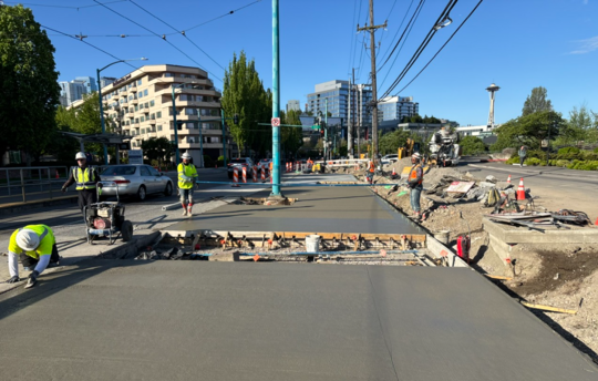 Crews pour new concrete to widen the west side of Fairview Ave N.