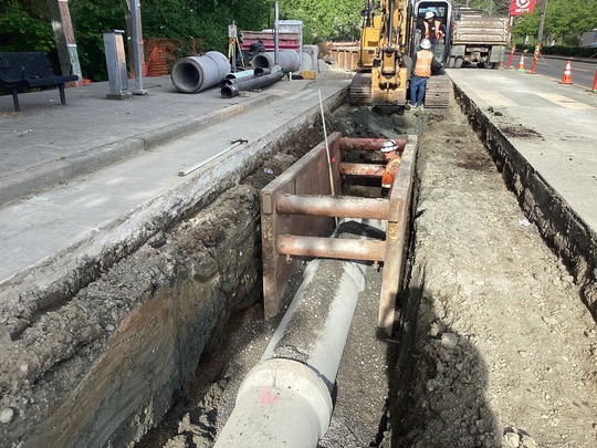 Construction site showing completed drainage and pipe installation.