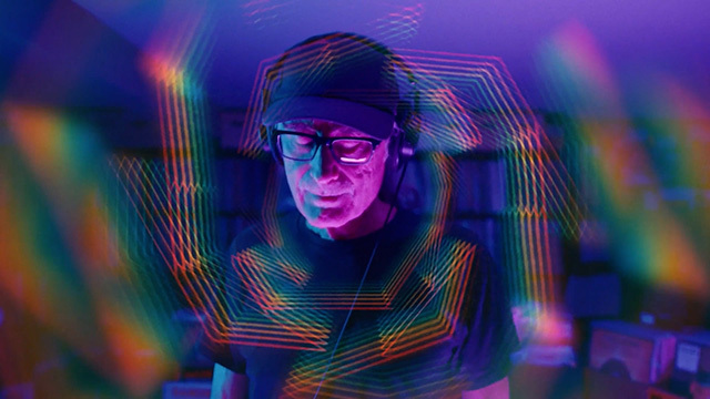 KEXP DJ Kevin Cole is framed with twinkling light.