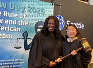 Presiding Judge Anita Crawford-Willis with a Law Day participant posing in a robe with a gavel