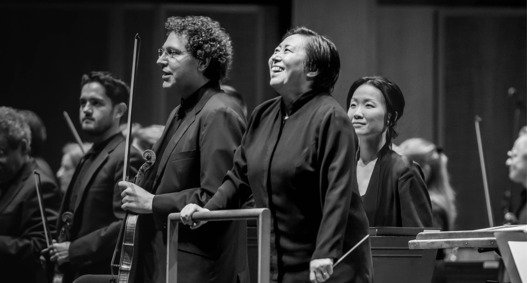 Music Director Xian Zhang conducts an orchestra