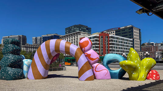 Large abstract shapes in colors and patterns on the King Street Station plaza.