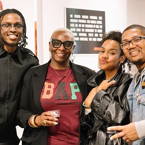 Four smiling individuals at ARTE NOIR