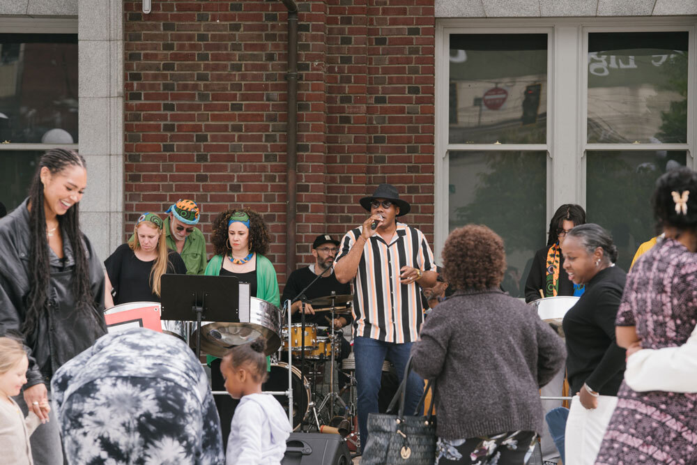 A band performs in front of a dancing crowd