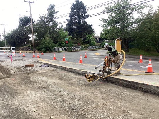 A crew member works to prepare for new concrete road panels.